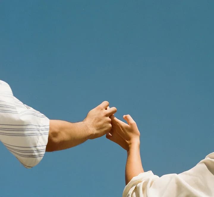 Parent and child reaching hands